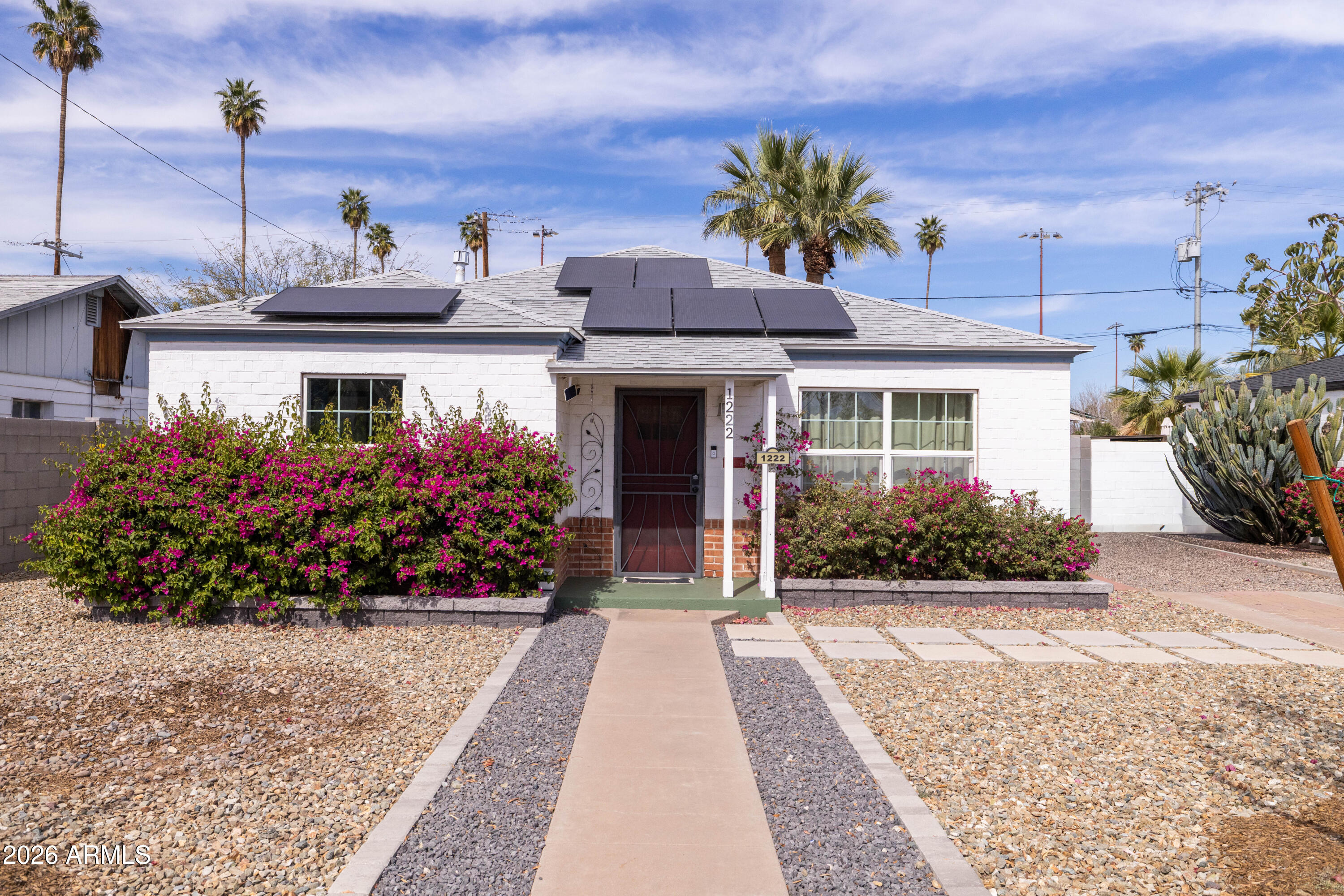 1222 East Almeria Road Phoenix, AZ 85006 - Photo 1 of 55 a front view of a house with a yard and a garden