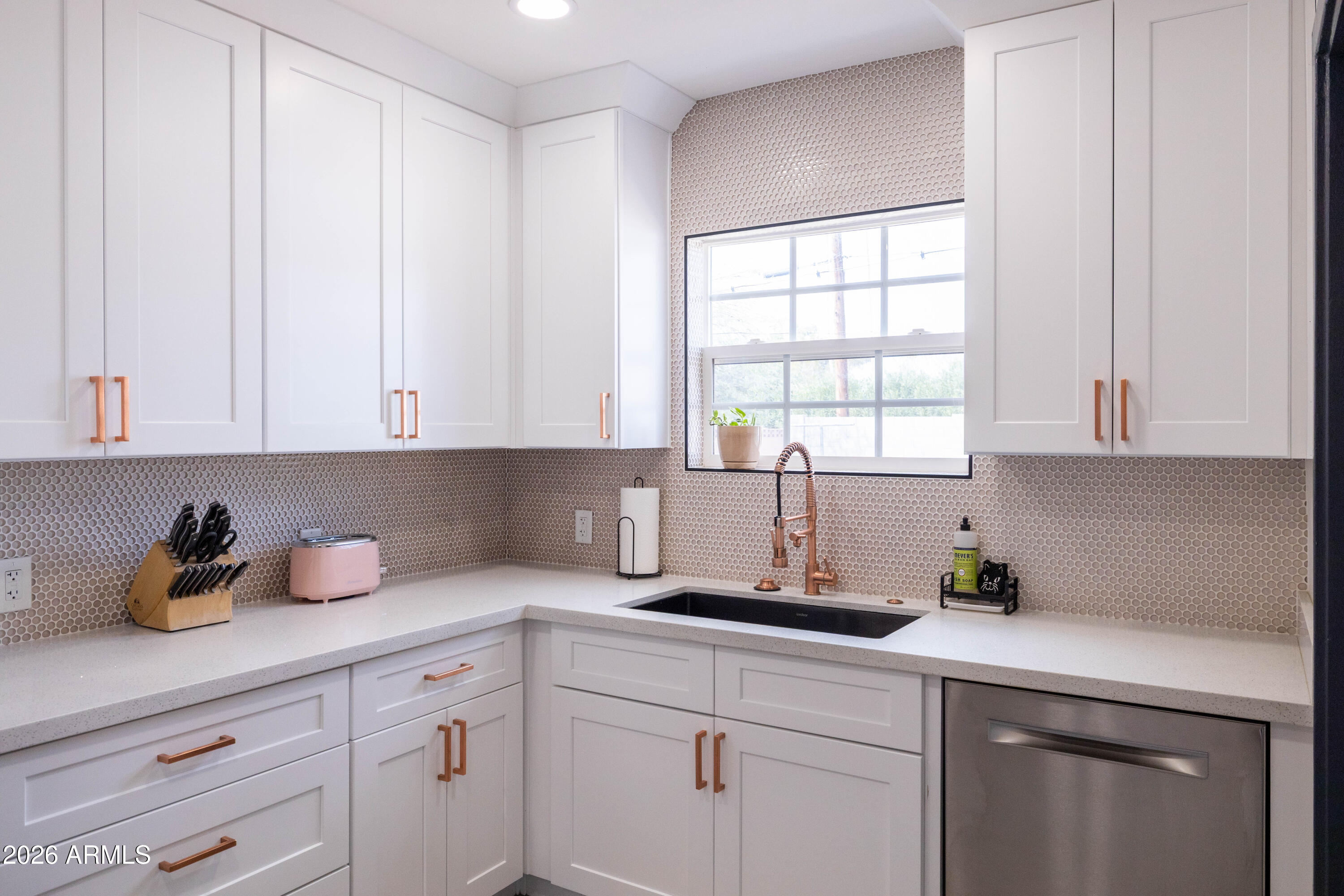 1222 East Almeria Road Phoenix, AZ 85006 - Photo 21 of 55 a kitchen with white cabinets and window
