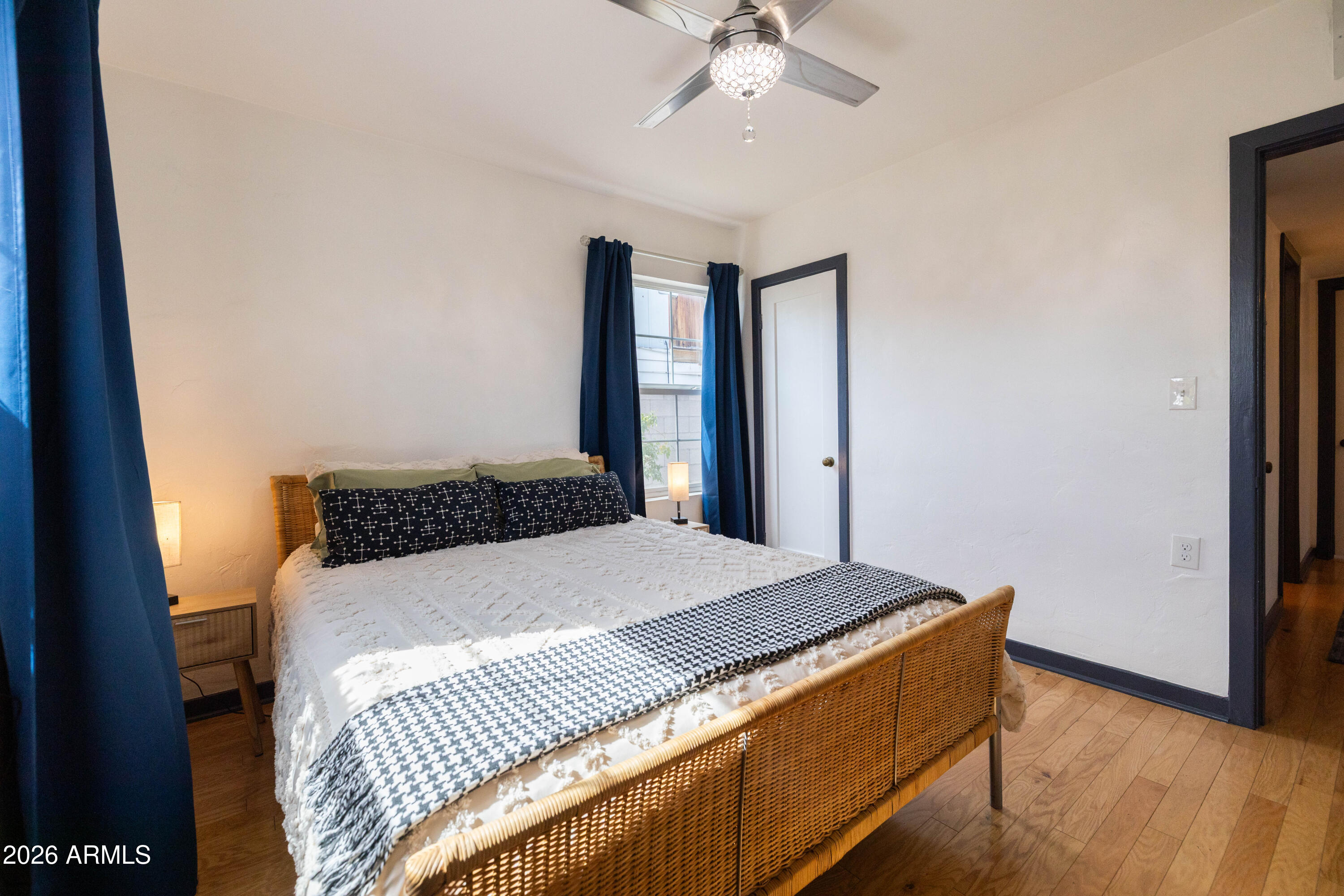 1222 East Almeria Road Phoenix, AZ 85006 - Photo 30 of 55 a bedroom with a large bed and a chandelier