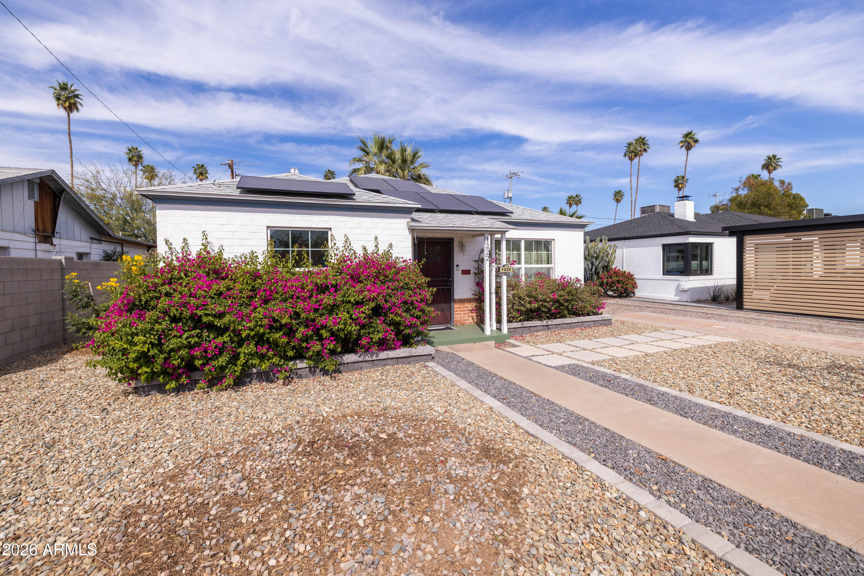 1222 East Almeria Road Phoenix, AZ 85006 - Photo 3 of 55 a front view of a house with a yard and potted plants