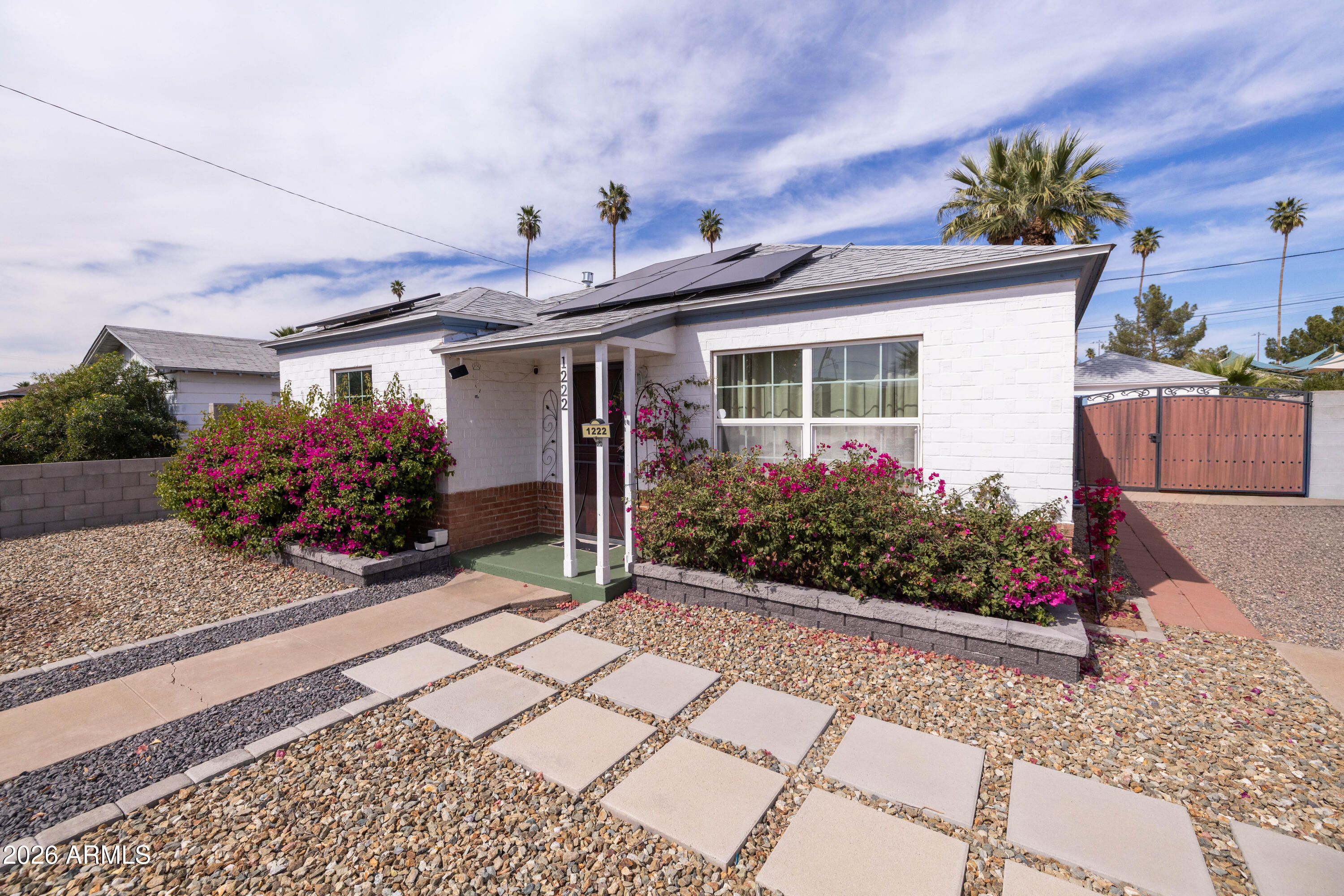 1222 East Almeria Road Phoenix, AZ 85006 - Photo 5 of 55 a front view of a house with lots of flowers and plants