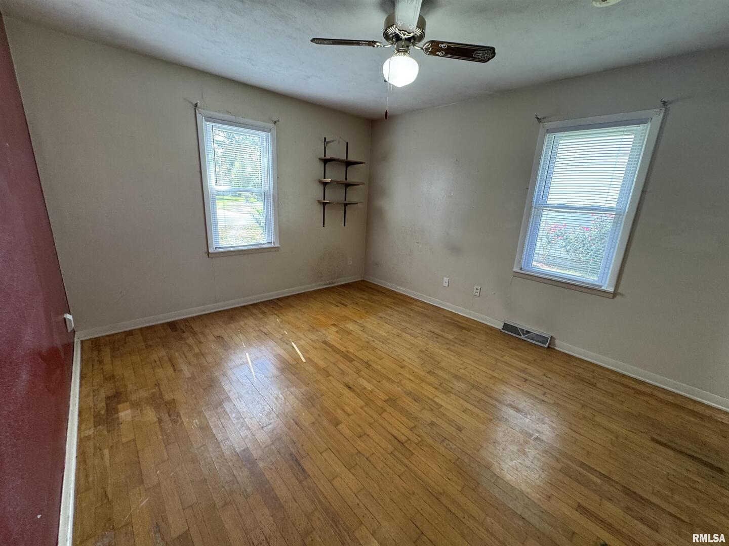 7 Holly Lane Flora, IL 62839 - Photo 26 of 42 a view of an empty room with a window and wooden floor