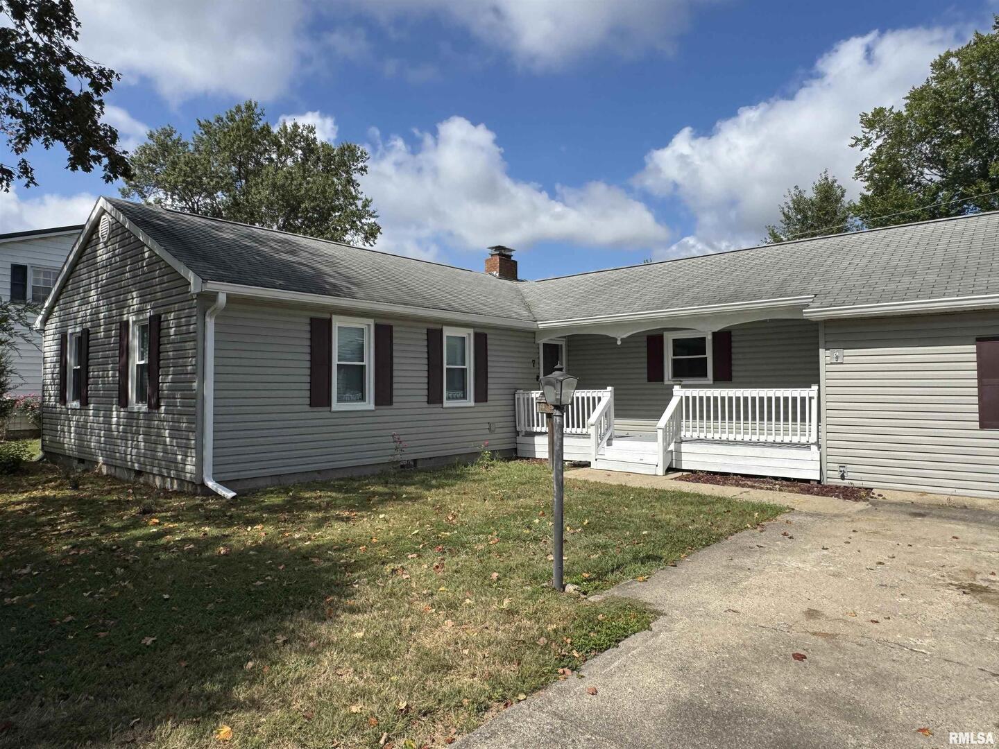 7 Holly Lane Flora, IL 62839 - Photo 35 of 42 a backyard of a house with potted plants and large tree