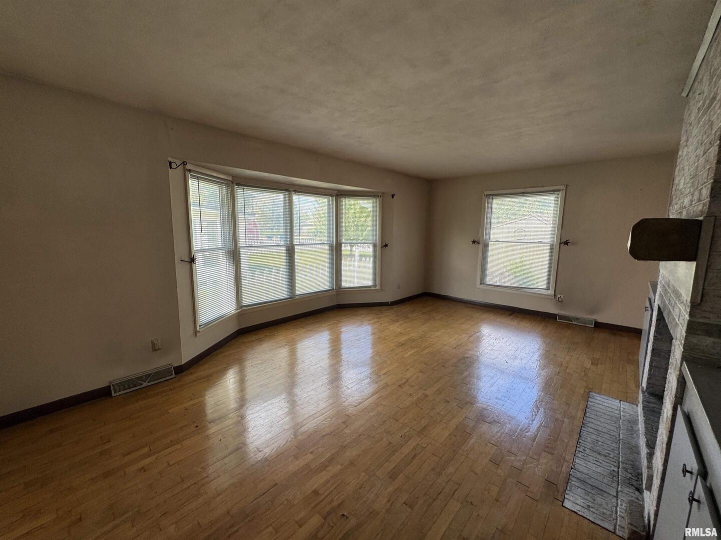 7 Holly Lane Flora, IL 62839 - Photo 4 of 42 a view of an empty room with a window and wooden floor