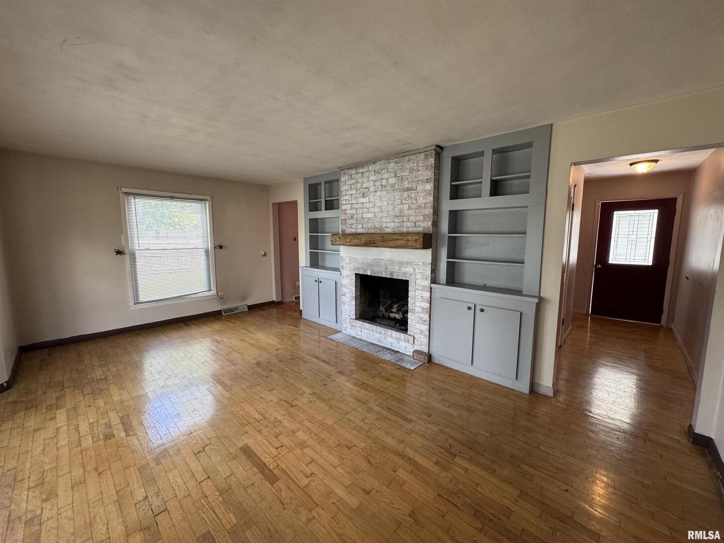 7 Holly Lane Flora, IL 62839 - Photo 5 of 42 a view of empty room with wooden floor and fireplace