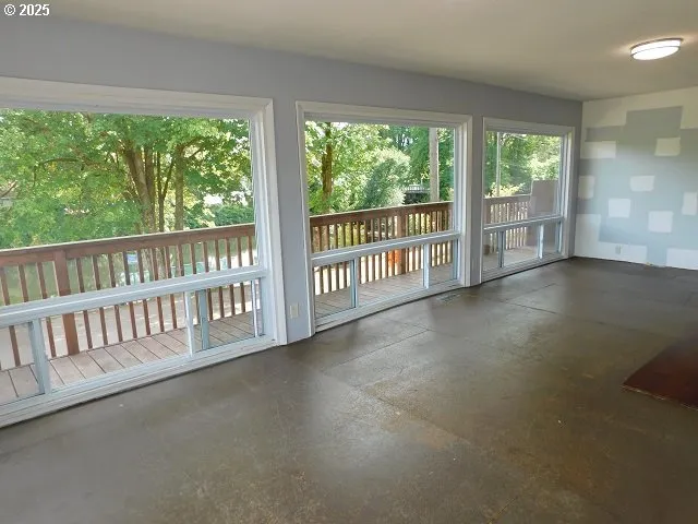 a view of a porch with wooden floor and fence