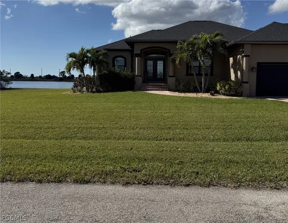 a front view of house with yard and trees