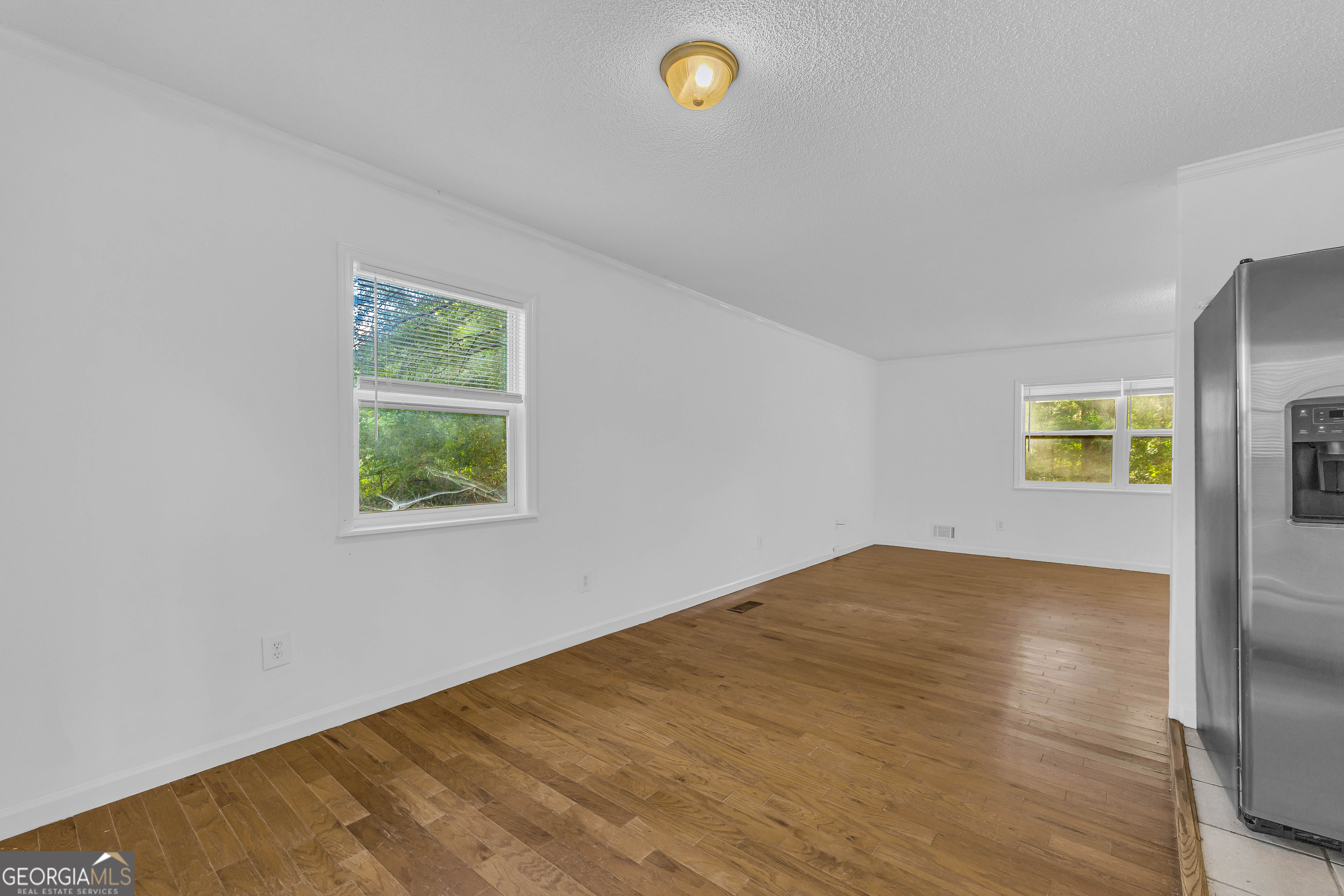 260 Pettit Lane Athens, GA 30605 - Photo 11 of 65 a view of empty room with window and wooden floor