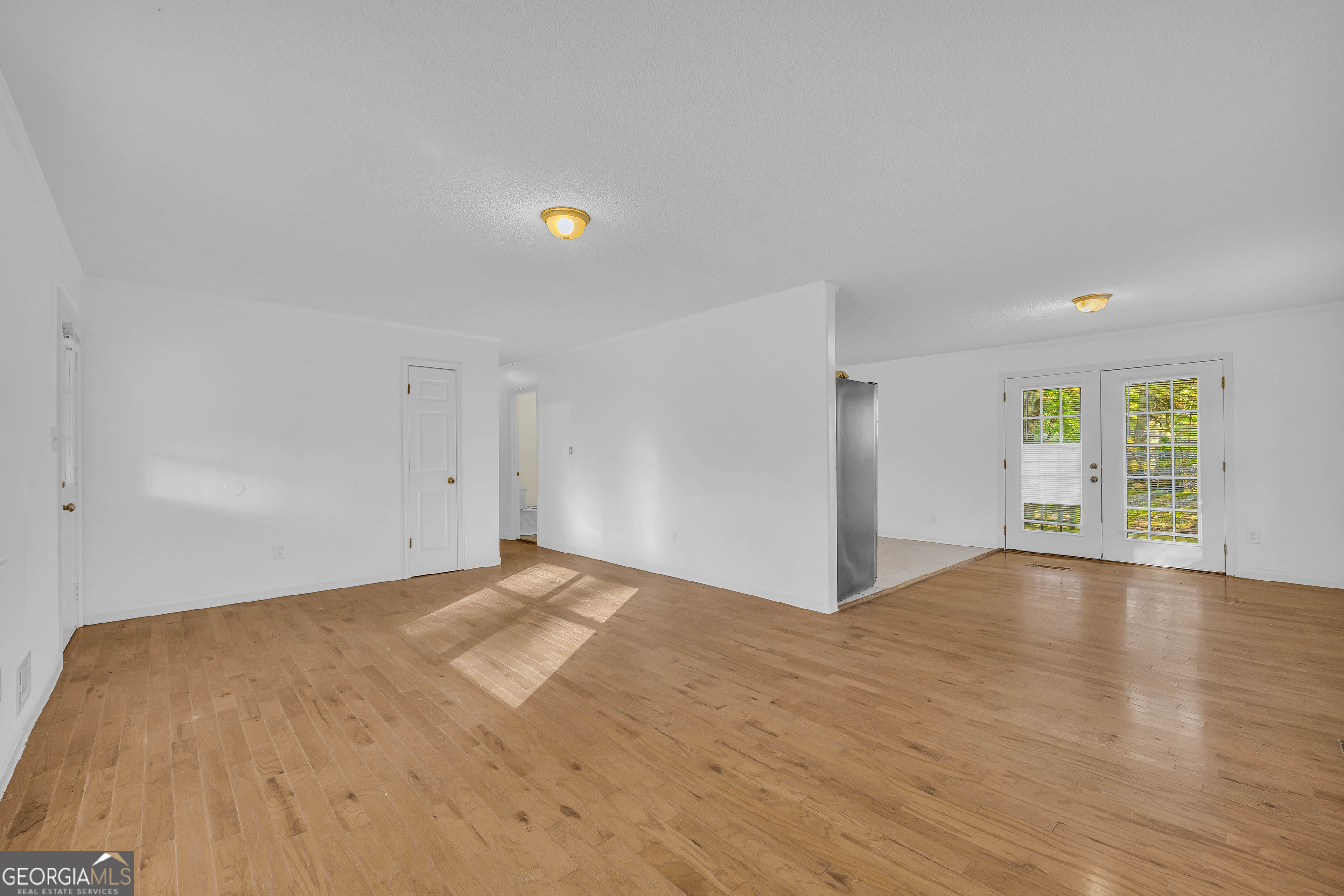 260 Pettit Lane Athens, GA 30605 - Photo 9 of 65 a view of an empty room with wooden floor and a window