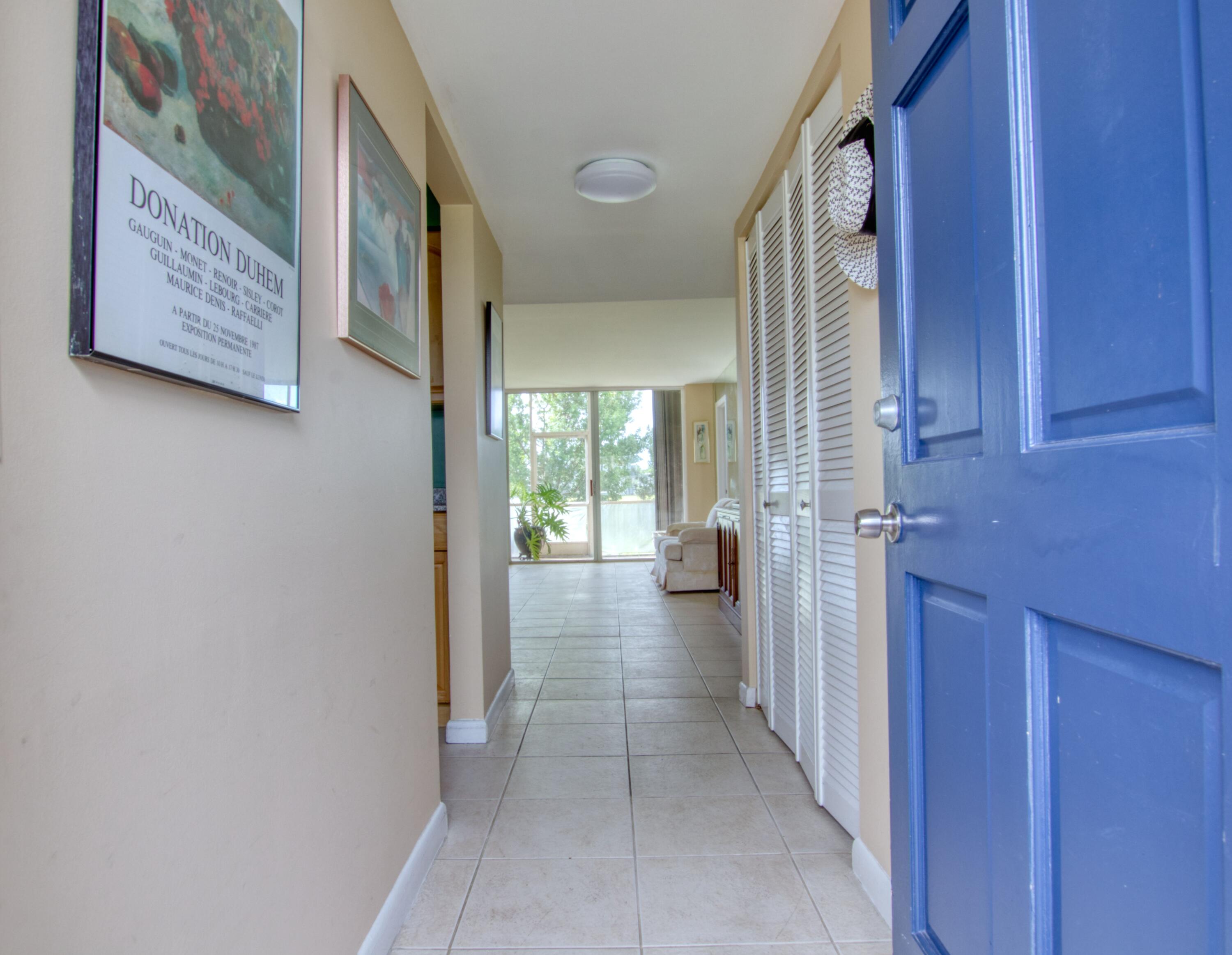 a view of a hallway with a furniture and a window
