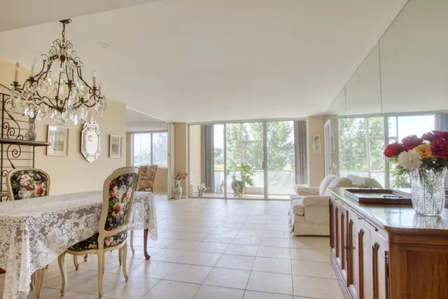 a dining room with furniture and a large window