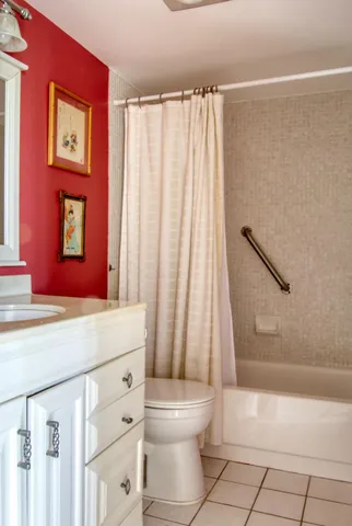 a bathroom with a shower curtain and a toilet