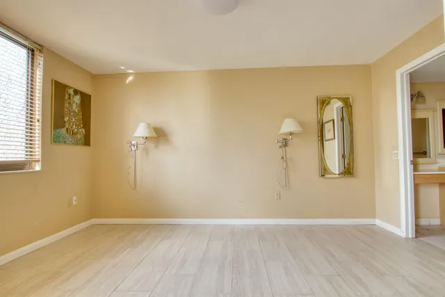 a view of room with window and wooden floor