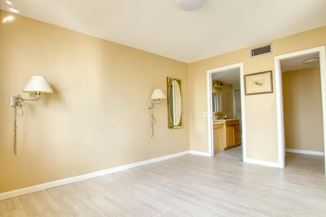 a view of a room with wooden floor staircase and a bathroom