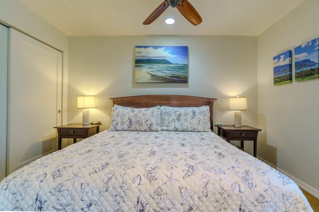 a bedroom with a bed and a painting on the wall