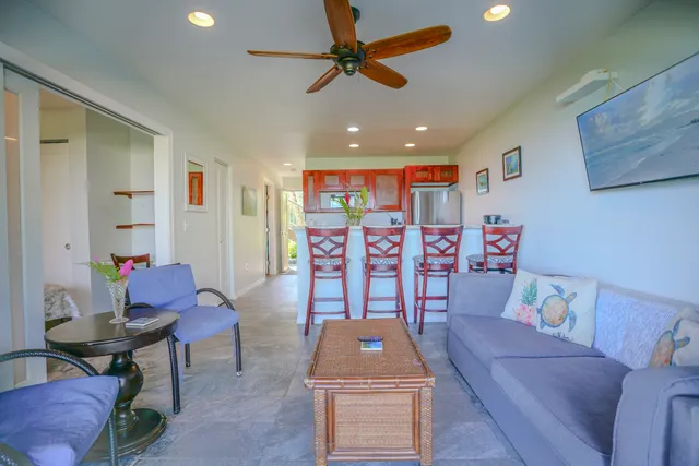 a living room with furniture and ceiling fan