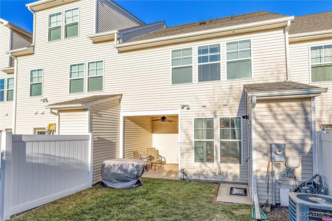 Rear view of property featuring central AC unit, a