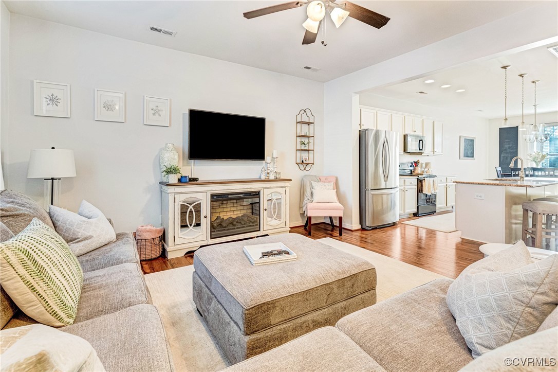 8061 Rutland Village Drive Mechanicsville, VA 23116 - Photo 4 of 22 Living room with ceiling fan, sink, and light wood