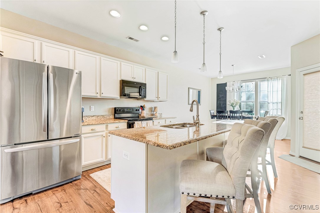 8061 Rutland Village Drive Mechanicsville, VA 23116 - Photo 8 of 22 Kitchen with sink, white cabinetry, black applianc