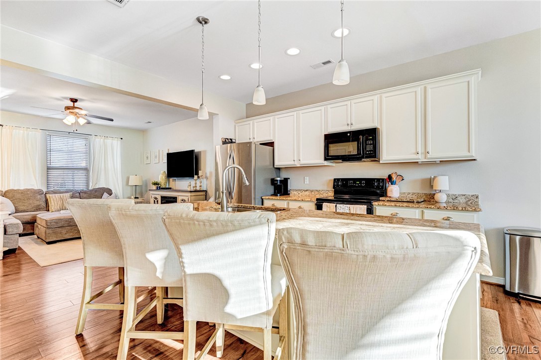 8061 Rutland Village Drive Mechanicsville, VA 23116 - Photo 9 of 22 Kitchen featuring white cabinetry, hanging light f