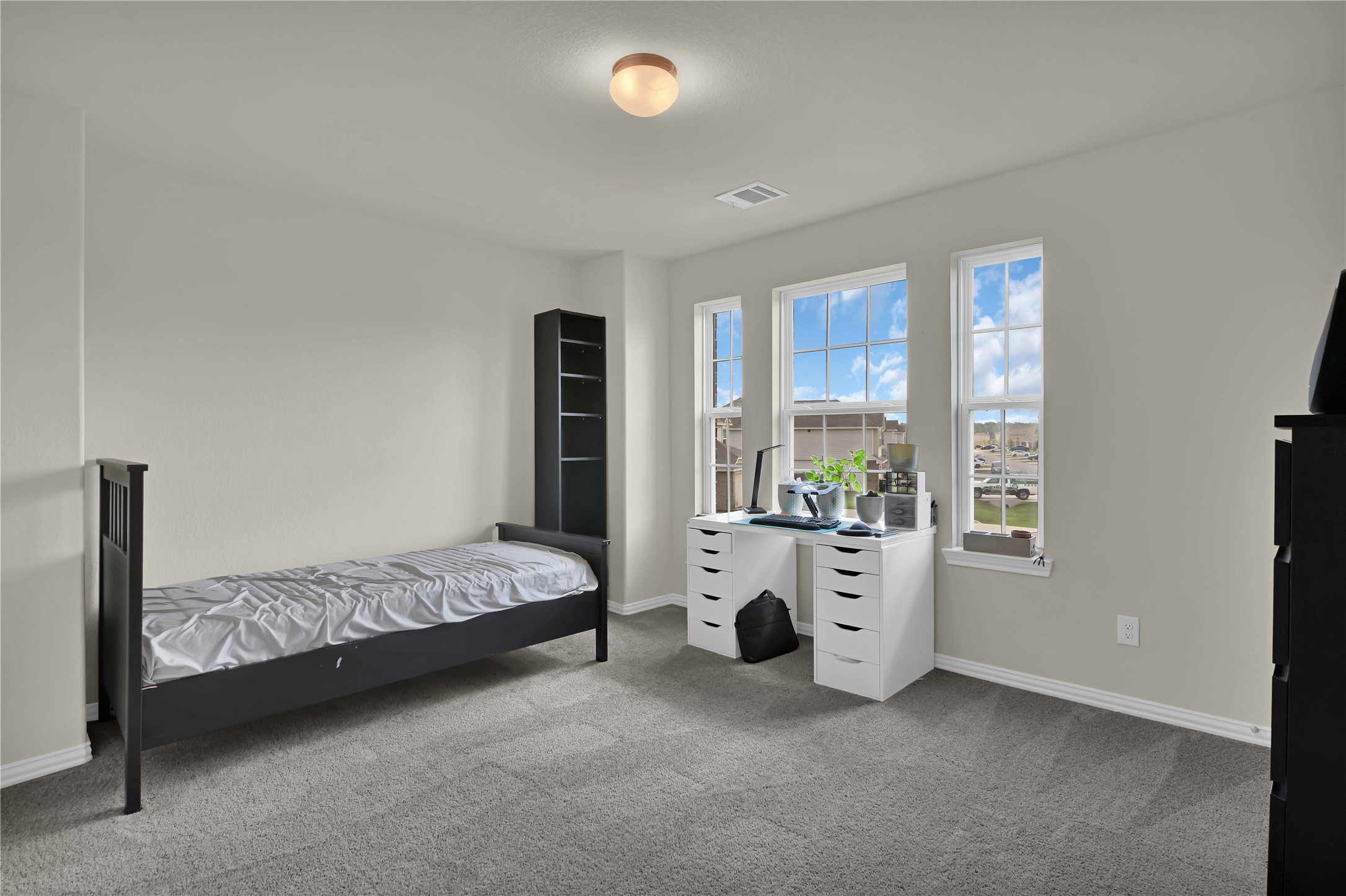 17703 Lion Heart Road Conroe, TX 77306 - Photo 22 of 26 a bed room with a bed and a window
