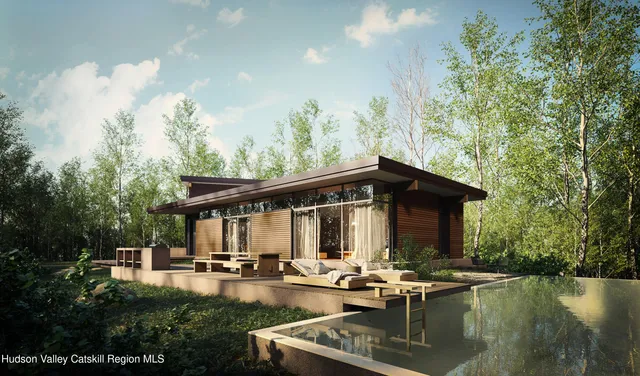 a view of a house with swimming pool and sitting area