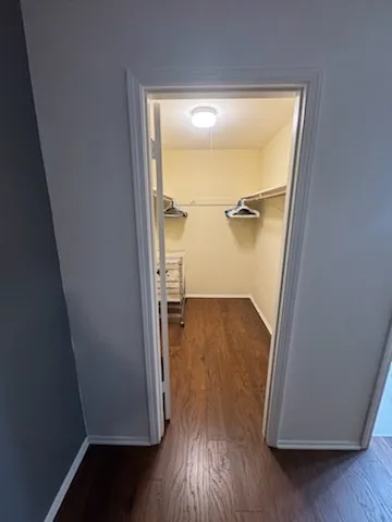 an empty room with wooden floor and a window