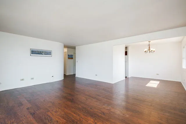 an empty room with wooden floor