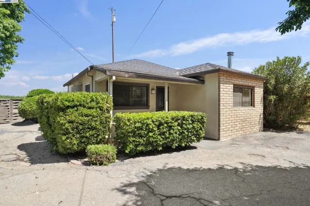 a view of a house with a swimming pool and yard