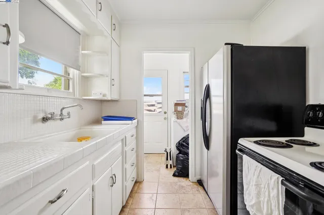 a view of a patio with table and chairs a fire pit with large trees