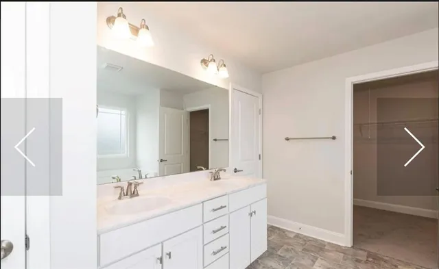 a bathroom with a double vanity sink and mirror
