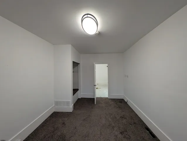 a view of a utility room with racks on the wall