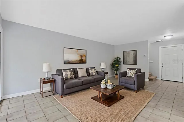 a living room with furniture and a lamp
