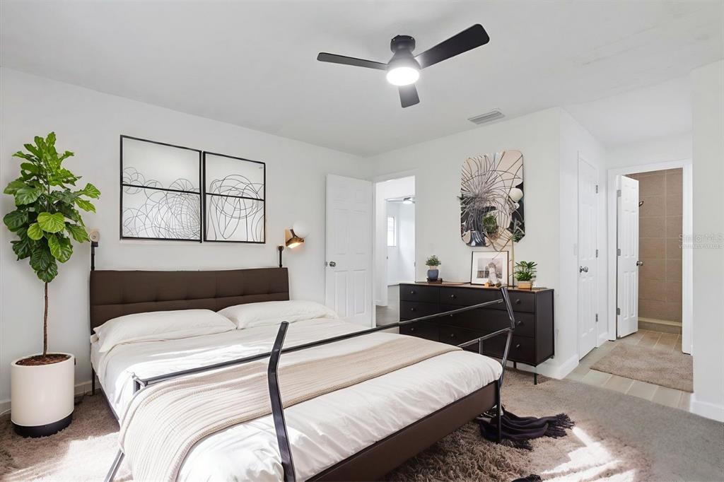 1125 Longfellow Way Sarasota, FL 34243 - Photo 16 of 43 a bedroom with a bed and a chandelier