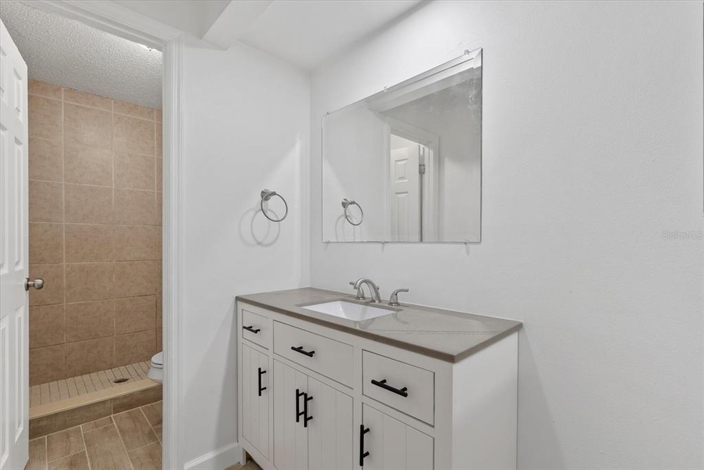 1125 Longfellow Way Sarasota, FL 34243 - Photo 19 of 43 a bathroom with a sink a toilet and shower