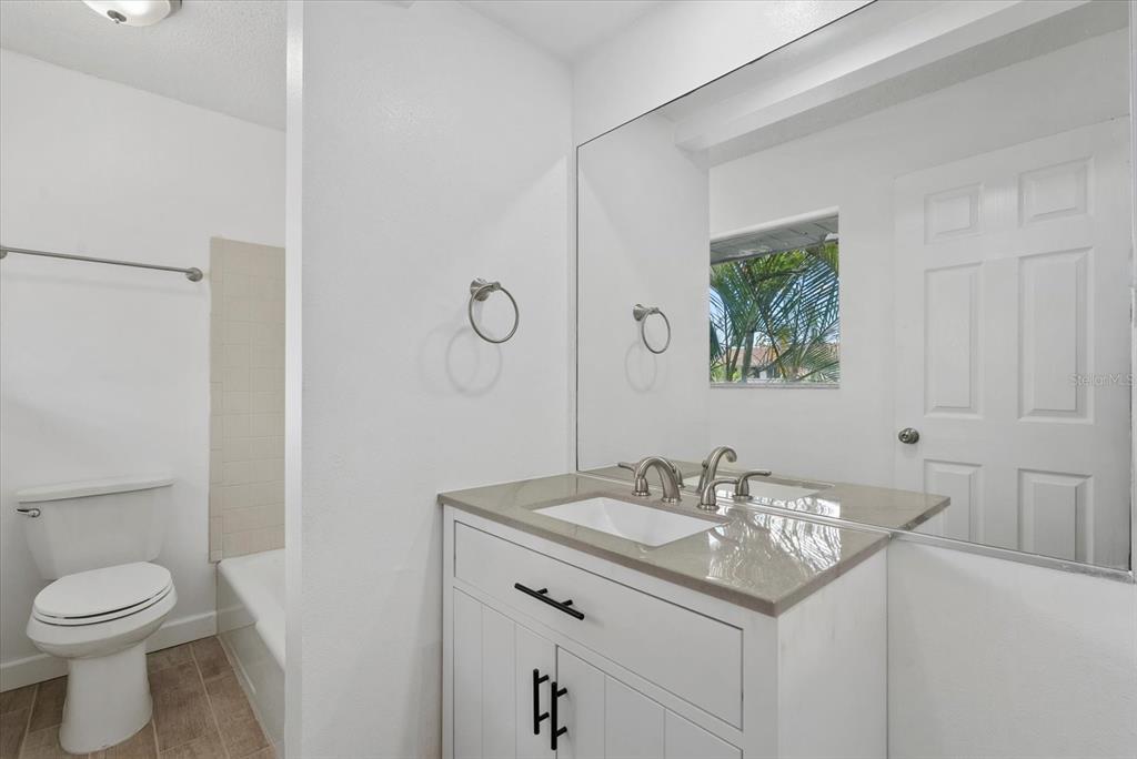 1125 Longfellow Way Sarasota, FL 34243 - Photo 21 of 43 a bathroom with a sink toilet and a mirror