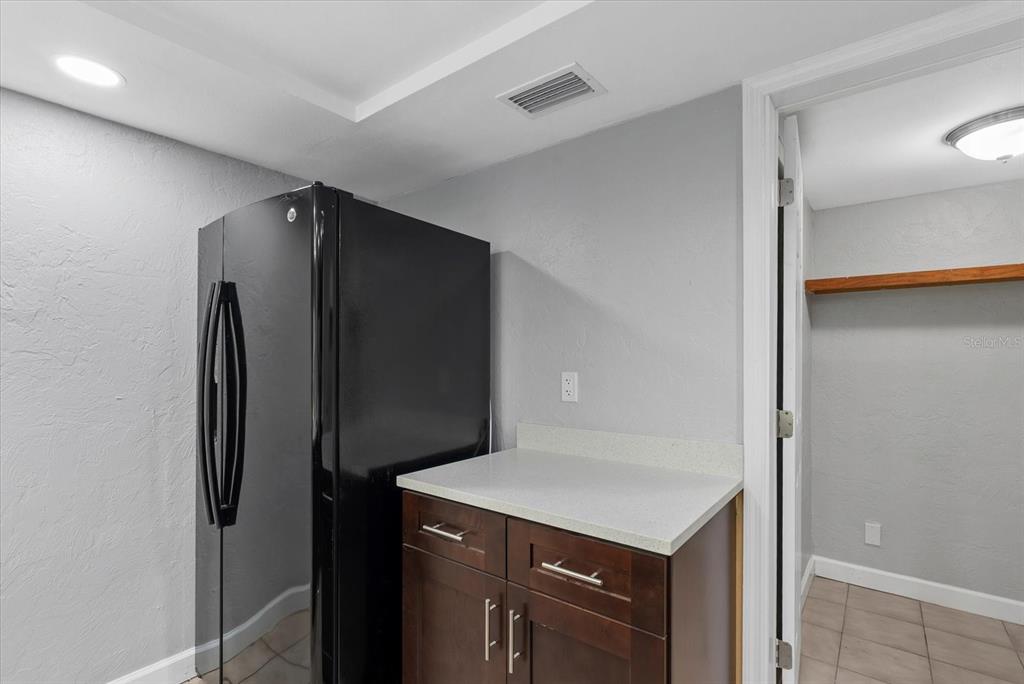 1125 Longfellow Way Sarasota, FL 34243 - Photo 7 of 43 a kitchen with a refrigerator and a sink