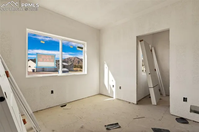 a view of small space with wooden floor and white walls