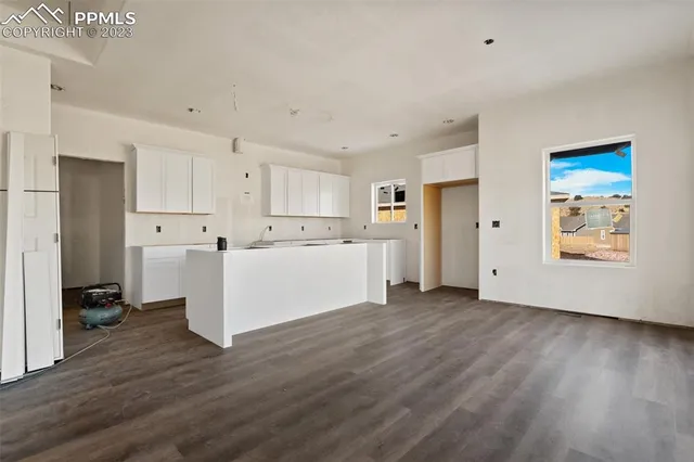 a view of a kitchen with wooden floor