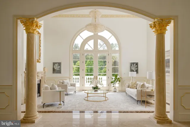 a living room with furniture a fireplace and a large window