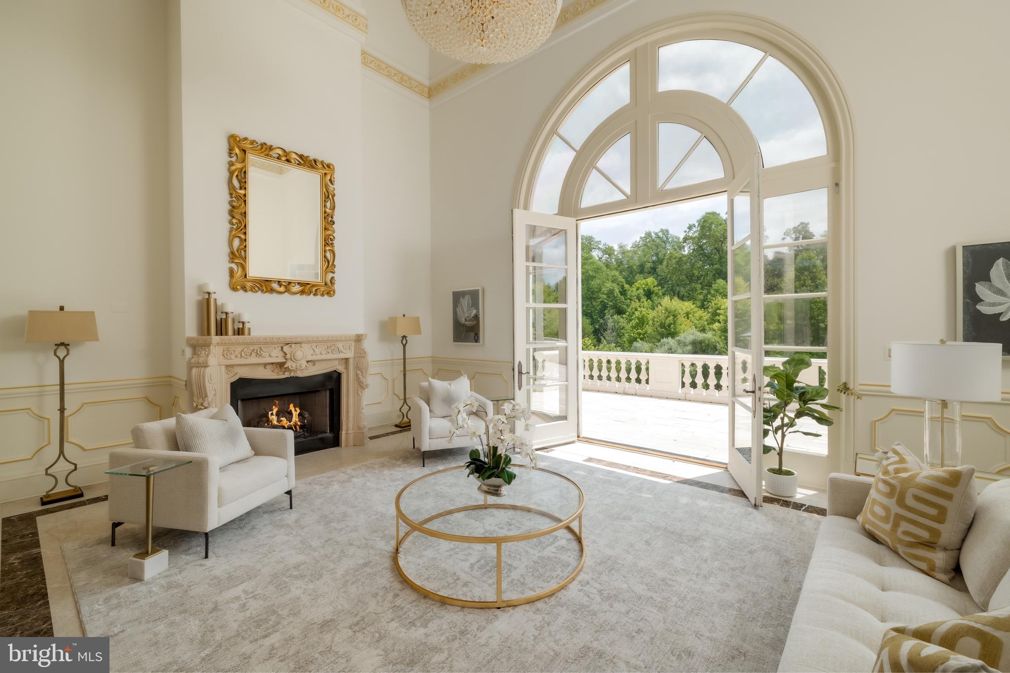 9431 Newbridge Drive Potomac, MD 20854 - Photo 16 of 50 a living room with furniture a fireplace and a large window