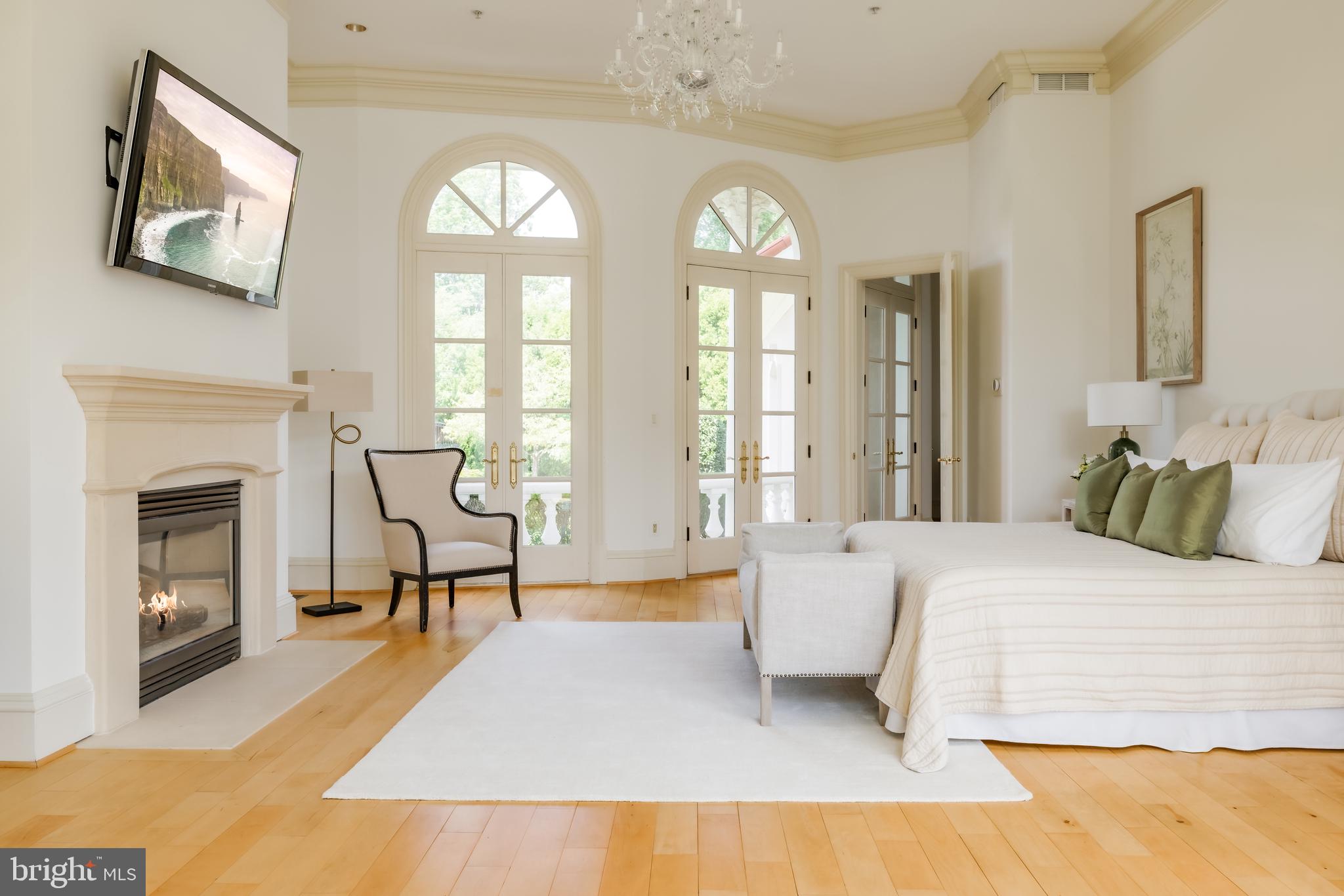 9431 Newbridge Drive Potomac, MD 20854 - Photo 29 of 50 a bedroom with a bed and a fireplace