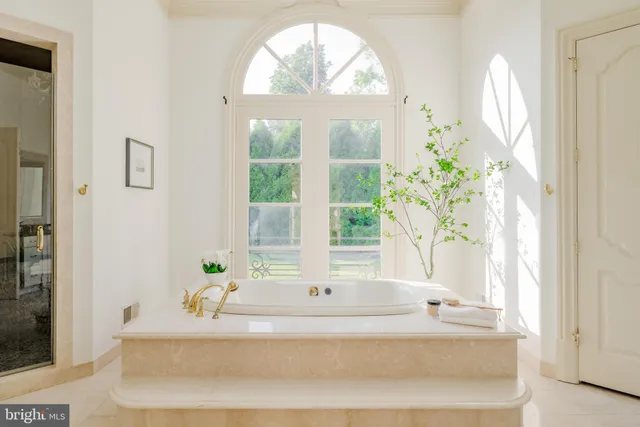 a bathroom with a tub sink and mirror