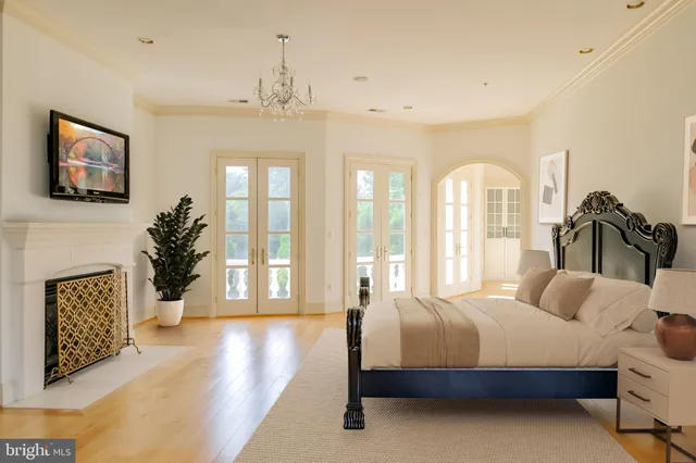 a spacious bedroom with a large bed and a fireplace