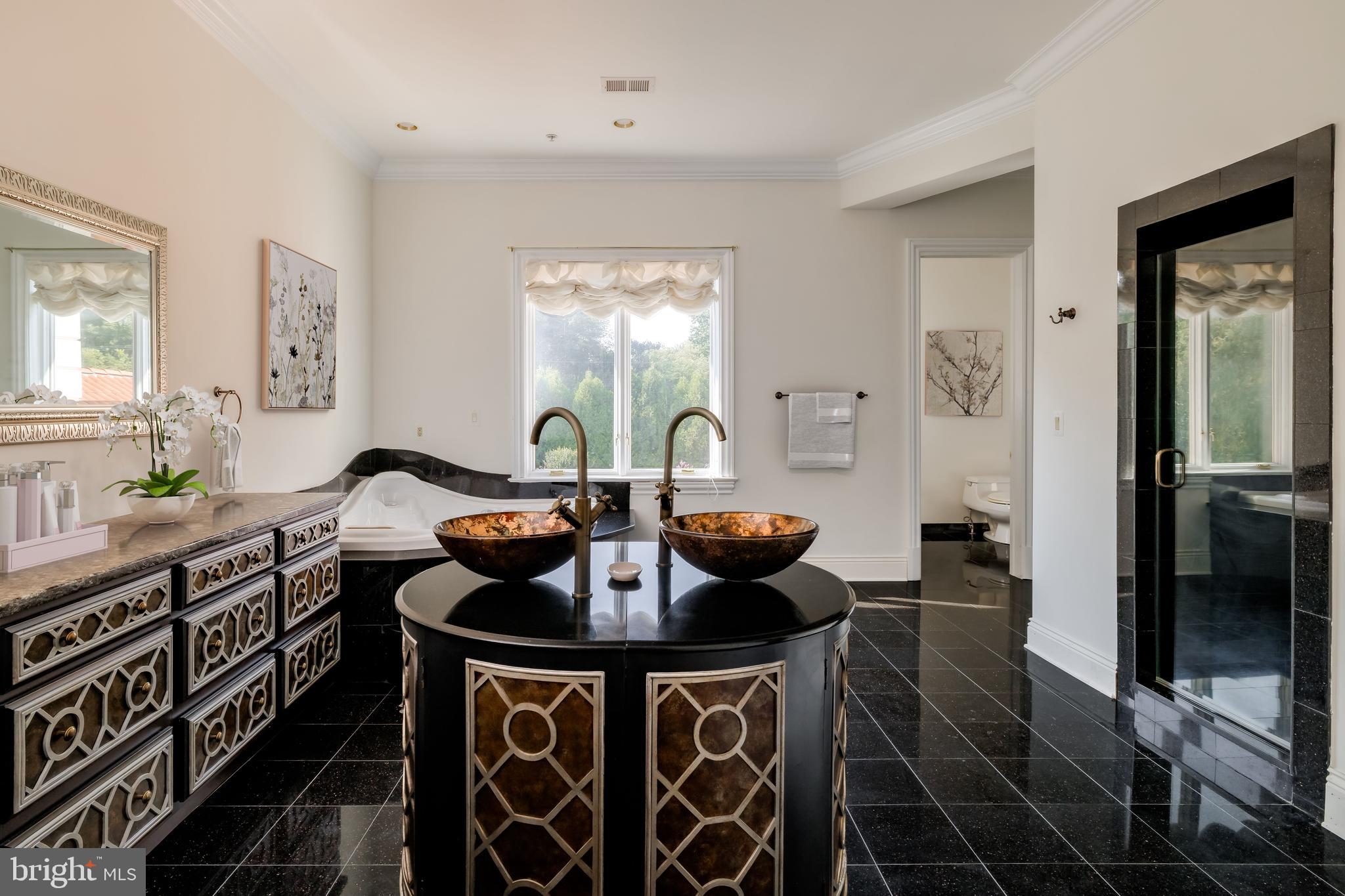 9431 Newbridge Drive Potomac, MD 20854 - Photo 38 of 50 a kitchen with a stove a sink and a refrigerator