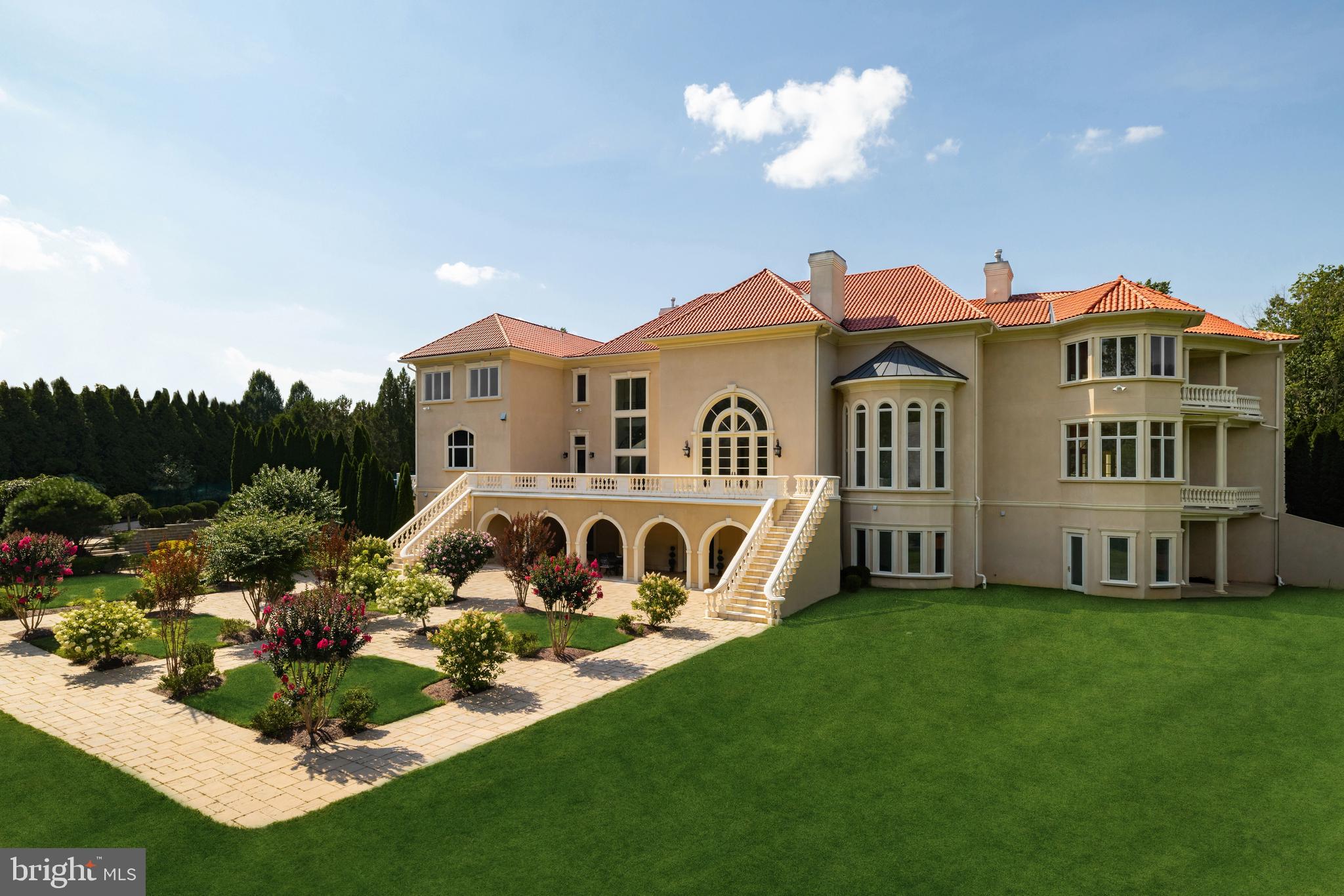 9431 Newbridge Drive Potomac, MD 20854 - Photo 44 of 50 a front view of a house with a garden and plants