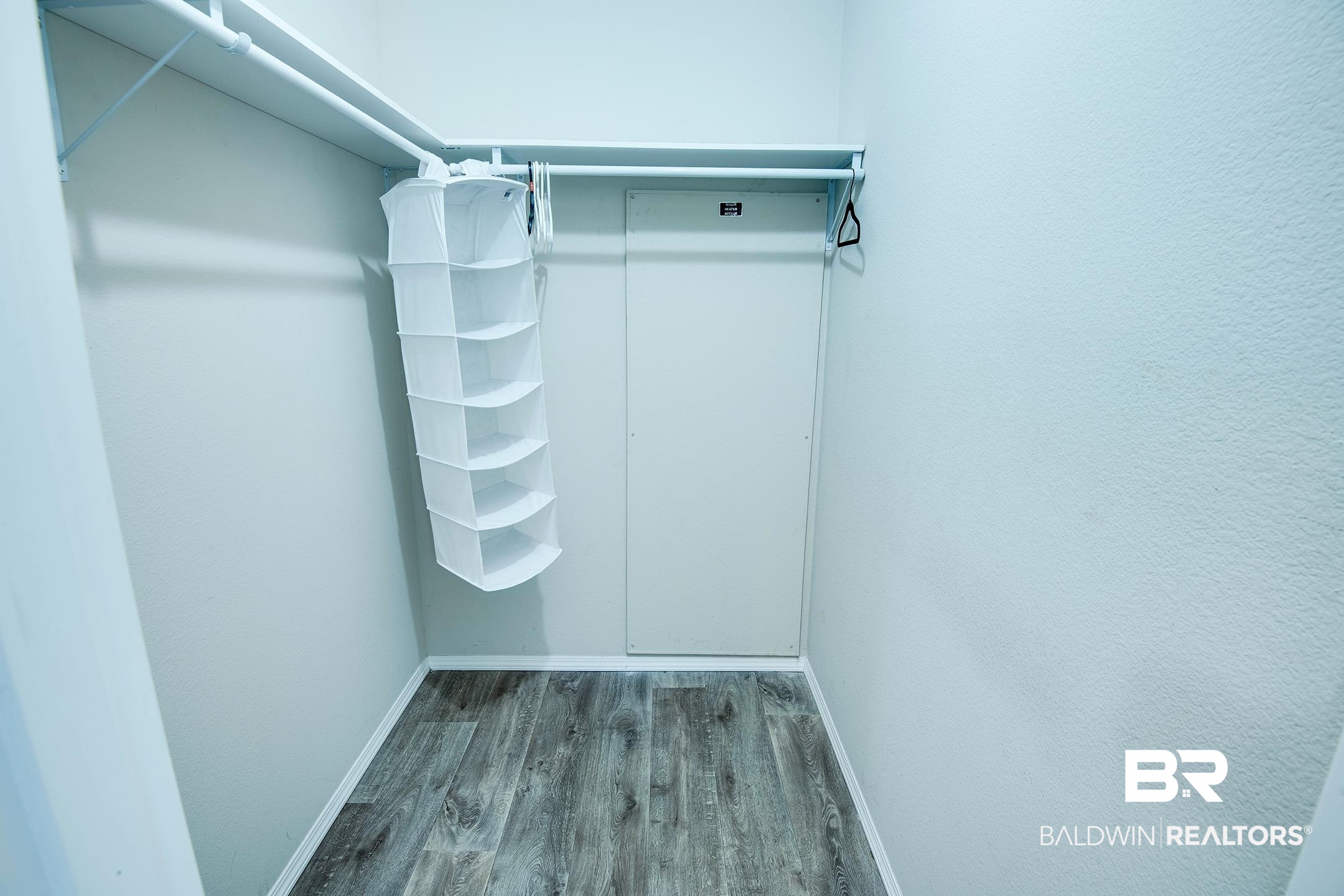 21859 West Side Loop Silverhill, AL 36576 - Photo 22 of 24 Walk in closet with hardwood / wood-style flooring
