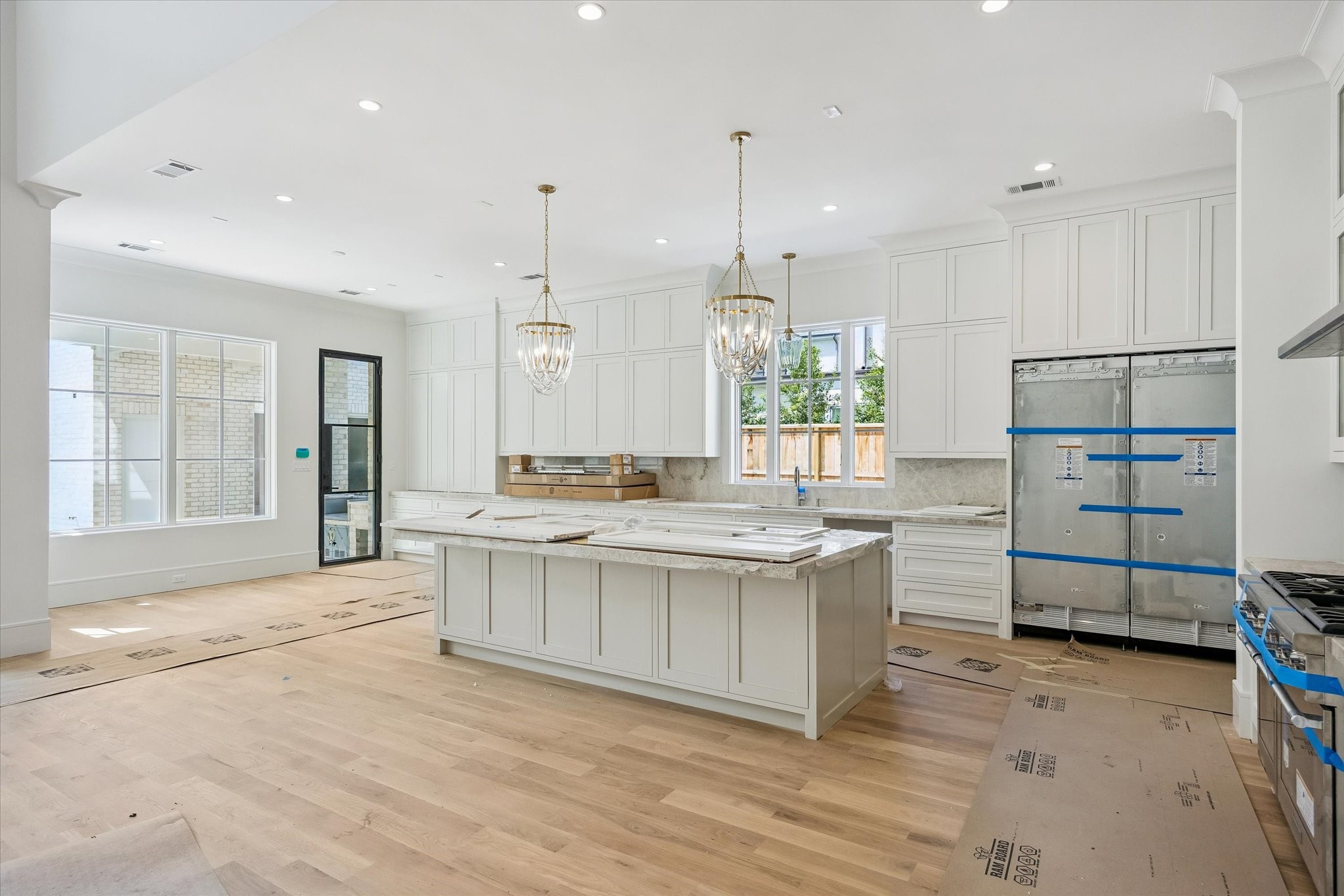 6011 Stones Throw Road Houston, TX 77057 - Photo 3 of 23 Kitchen – features designer pendant lighting, quartzite countertops, a spacious island, floor-to-ceiling cabinetry, and a charming breakfast nook.