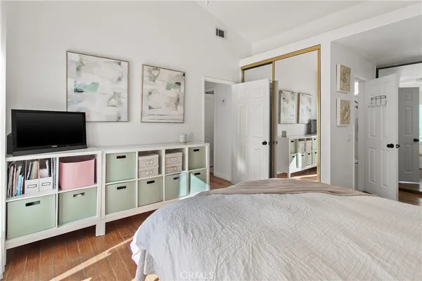 a bedroom with a bed and a flat screen tv