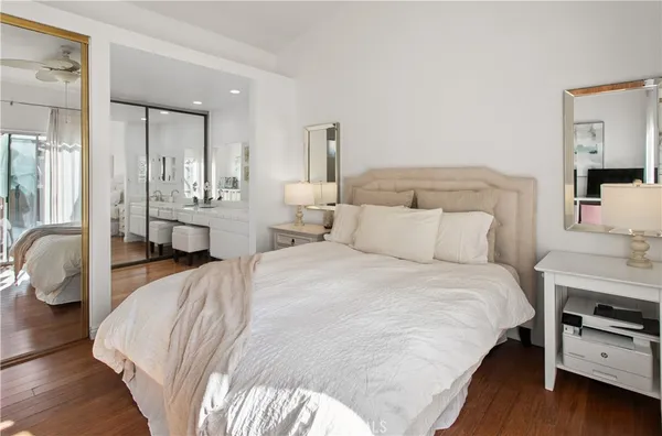a bedroom with a bed a couch and dresser